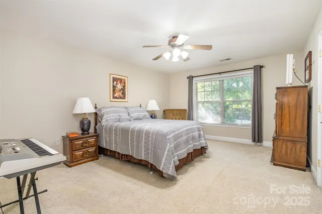 a spacious bedroom with a bed and a table in it