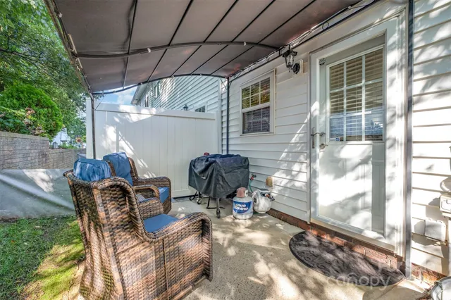 a view of a patio with table and chairs and potted plants