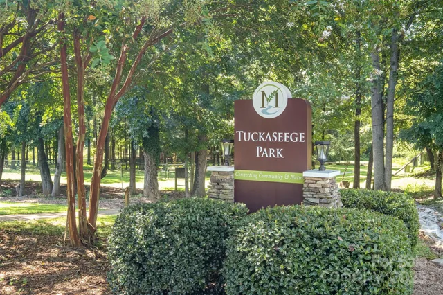 a wooden sign that is on a brick wall
