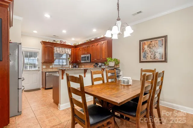 a view of a dining room with furniture and a chandelier