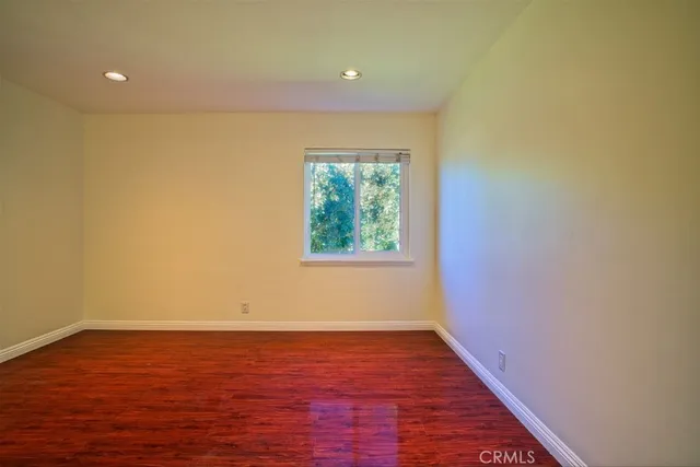 a view of room with window and wooden floor