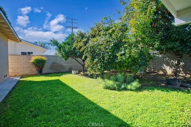 a backyard of a house with a garden and plants