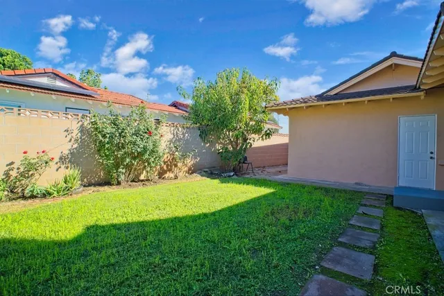 a view of a backyard with plants and a patio