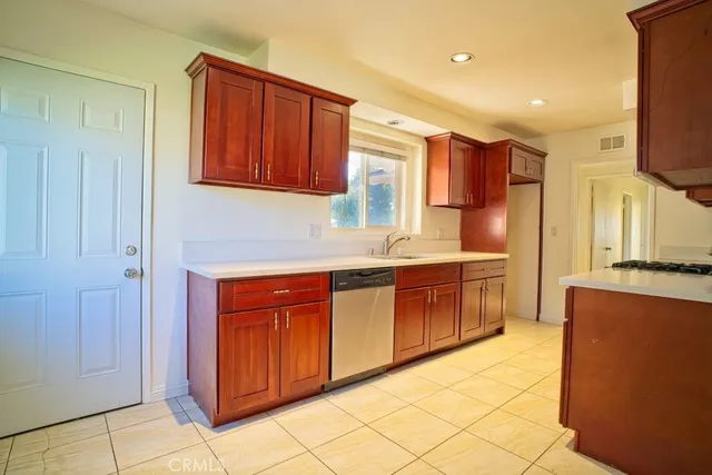 a kitchen with stainless steel appliances granite countertop a refrigerator and a stove top oven