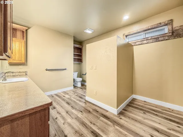 a bathroom with a granite countertop sink mirror and shower
