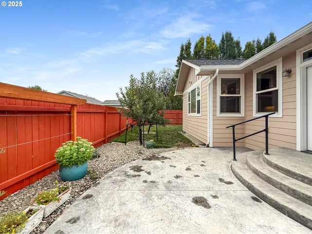a backyard of a house with yard fountain and outdoor seating