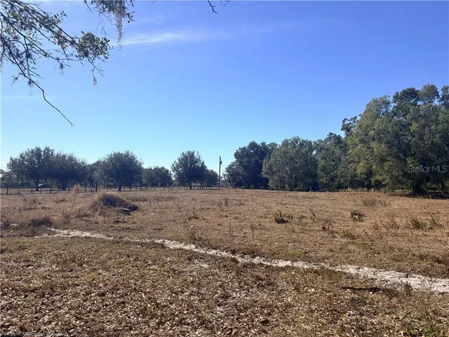 a view of top of a field with trees in background