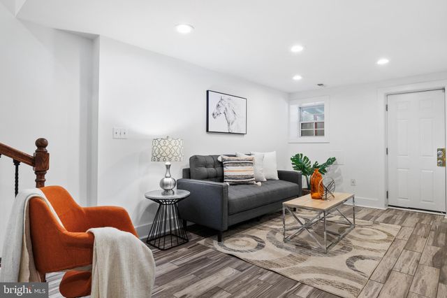 a living room with furniture a rug and a window