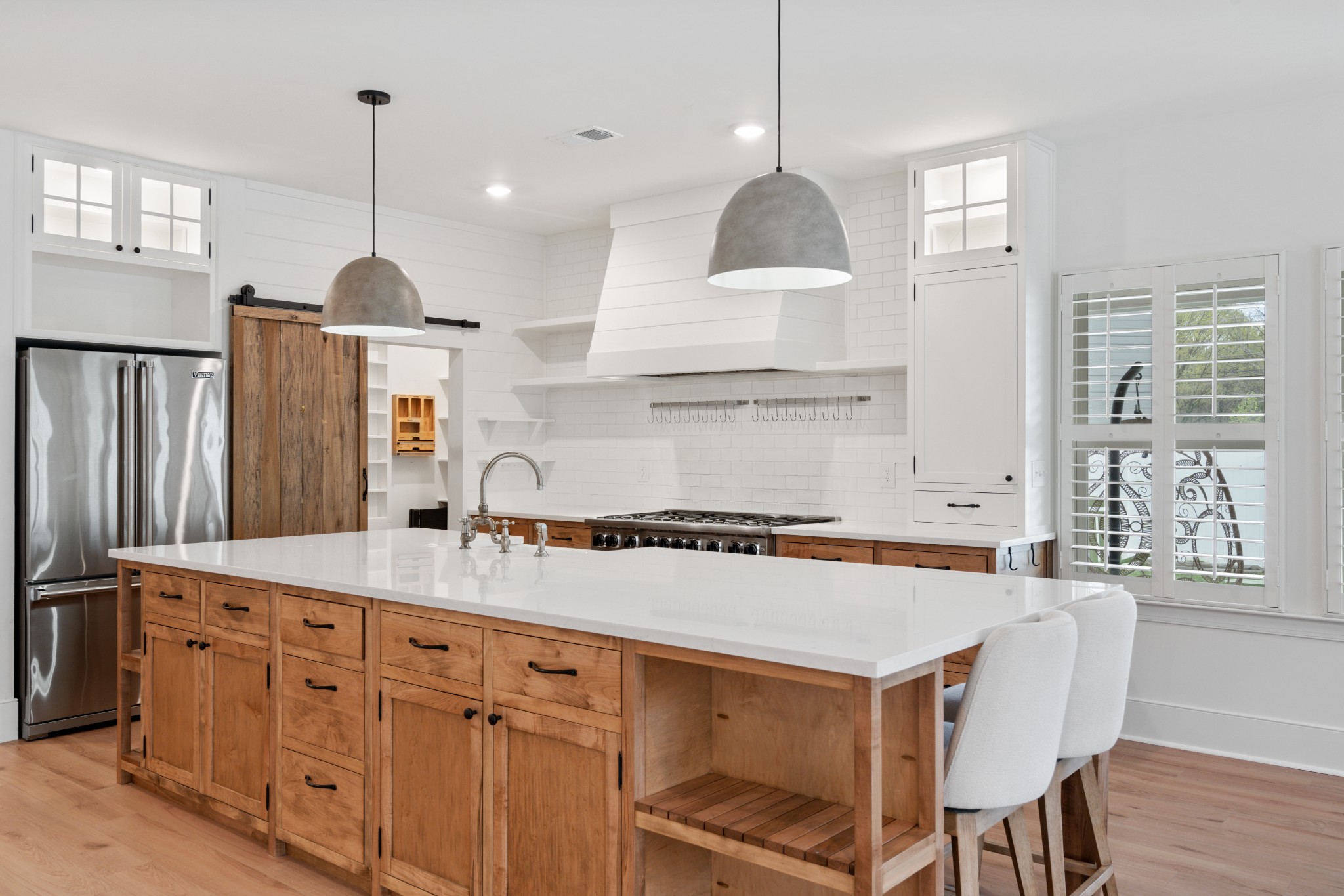 2056 Notchleaf Road Antioch, TN 37013 - Photo 4 of 42 a kitchen with stainless steel appliances granite countertop a sink a stove a refrigerator and island with wooden floor