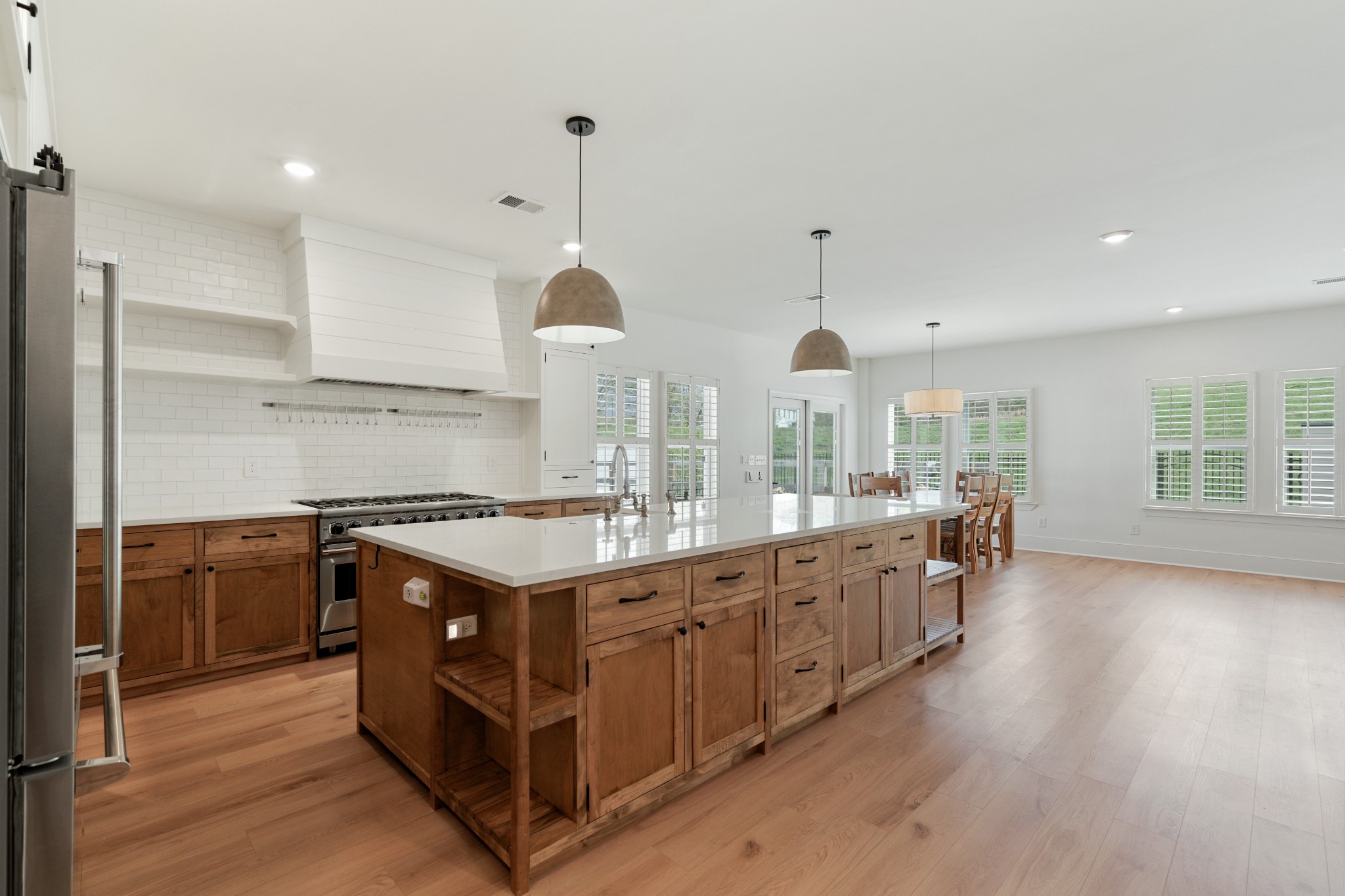 2056 Notchleaf Road Antioch, TN 37013 - Photo 6 of 42 a kitchen with stainless steel appliances granite countertop a stove oven and a refrigerator with wooden floors