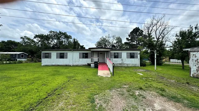 a front view of a house with swing and yard