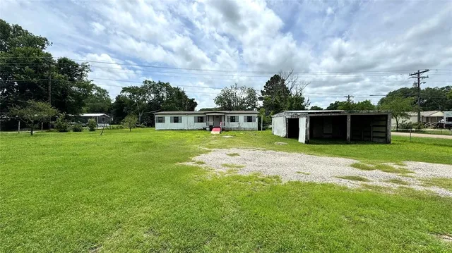 a view of a backyard with a garden and entertaining space
