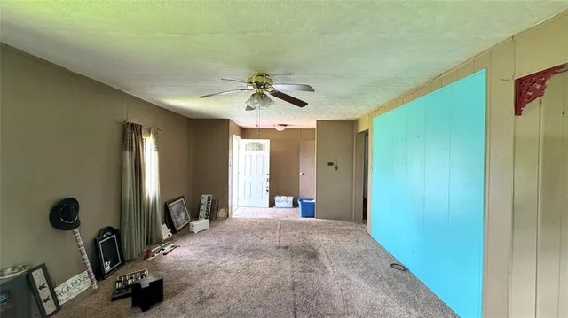 a view of a livingroom with a furniture and a ceiling fan
