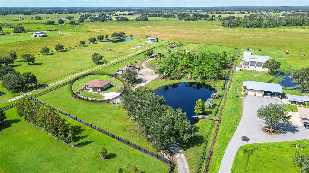 14318 MJ Road Myakka City, FL 34251 - Photo 1 of 1 an aerial view of a house with a garden and lake view