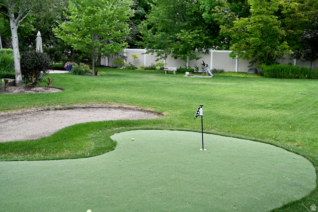 314 Brown Farm Lane Draper, UT 84020 - Photo 43 of 57 Expansive lawn featuring a putting green with flag, a sand trap, mature trees, and a privacy fence