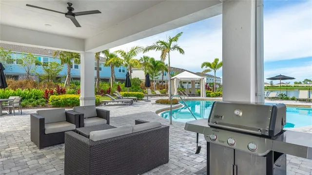 a living room with patio furniture and a potted plant