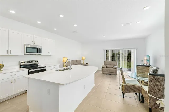 a kitchen with sink cabinets and living room