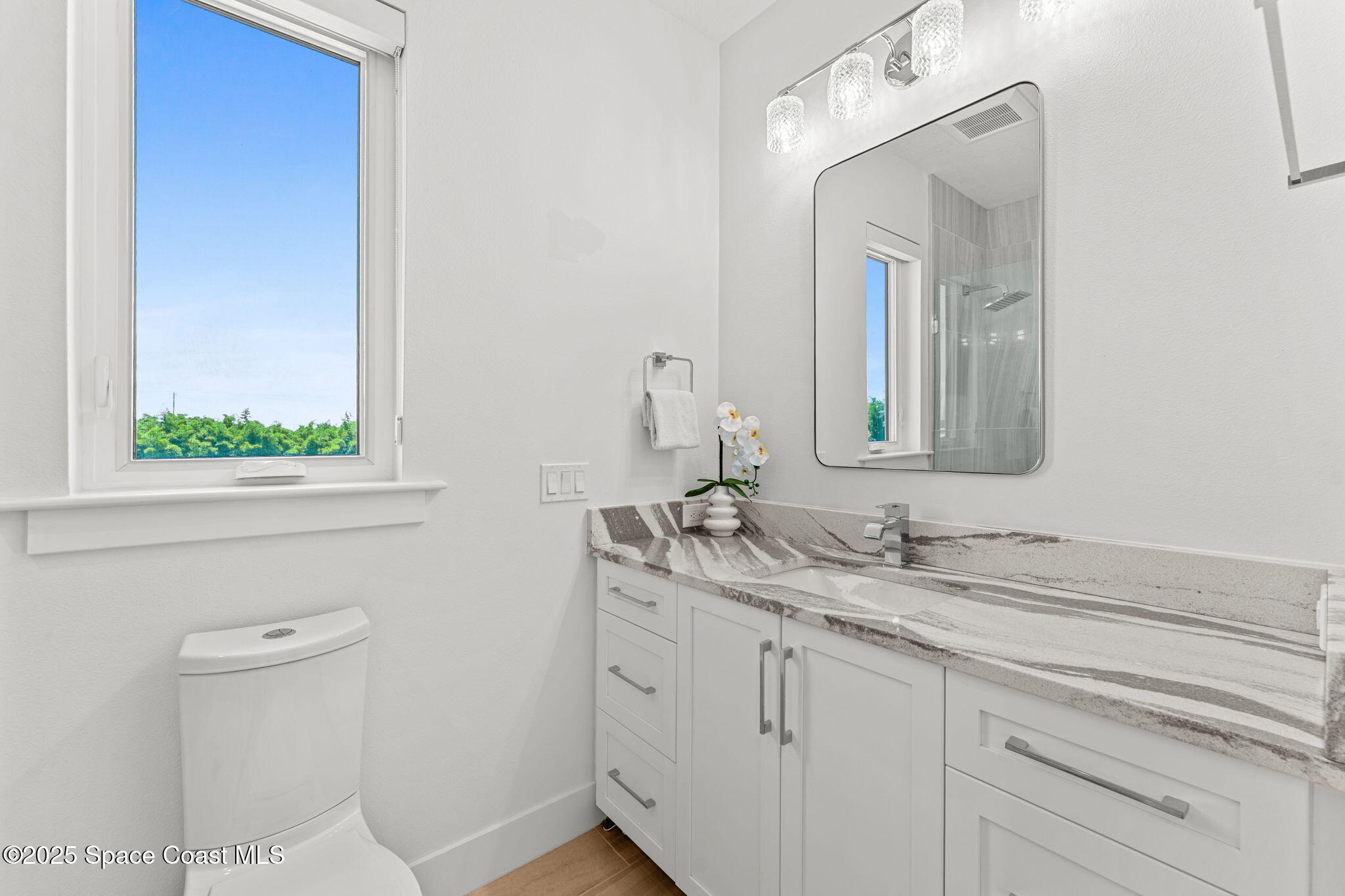 1949 Rockledge Drive Rockledge, FL 32955 - Photo 27 of 48 a bathroom with a double vanity sink and a mirror