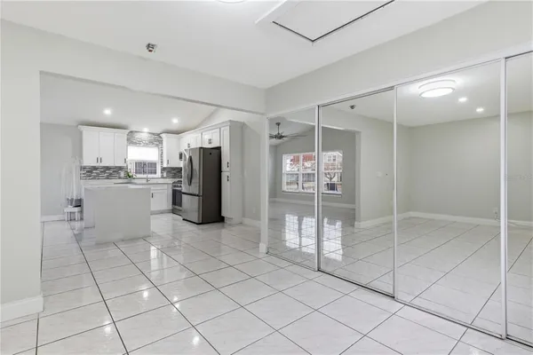 a kitchen with stainless steel appliances kitchen island granite countertop a refrigerator and a sink