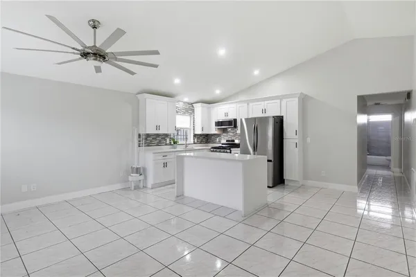 a kitchen with white cabinets and white stainless steel appliances