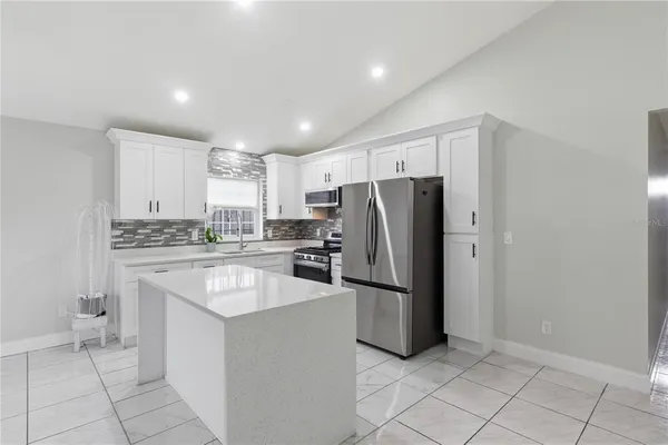 a kitchen with refrigerator and cabinets