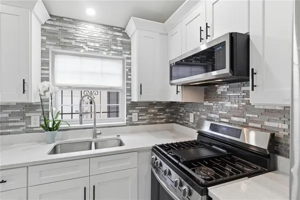 a kitchen with a stove and a sink