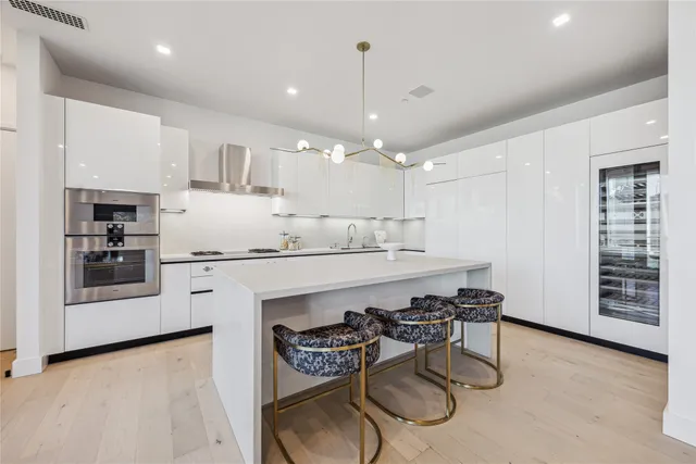 a kitchen with a table chairs stove and cabinets