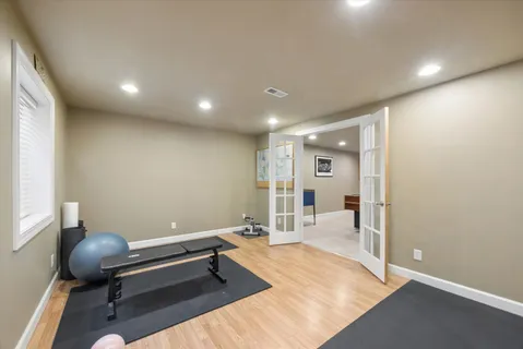 a hallway with a chair and wooden floor