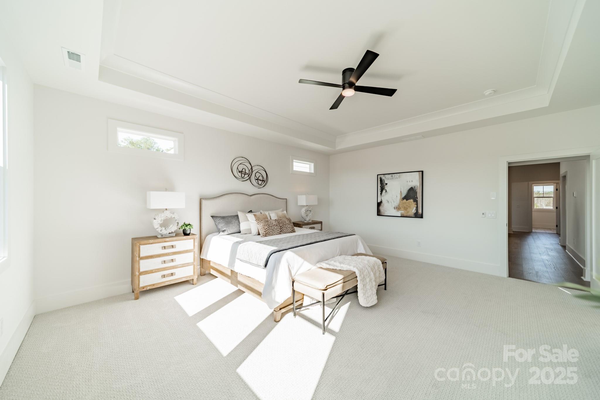 19032 Newburg Hill Road, Unit 23 Davidson, NC 28036 - Photo 16 of 39 a bedroom with a bed and a large mirror
