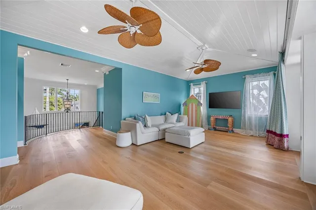a living room with kitchen island furniture and a wooden floor