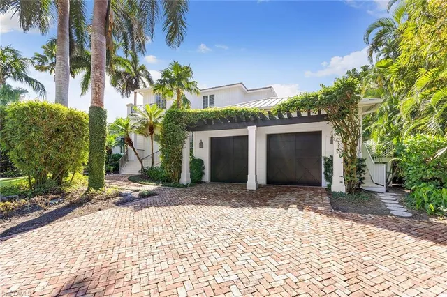 a front view of a house with a yard and a garage