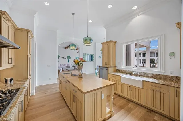 a kitchen with a sink stove and wooden cabinets