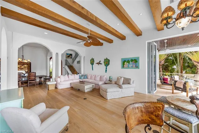 a living room with fireplace furniture and a large window