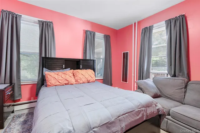 a bedroom with a bed and a large window