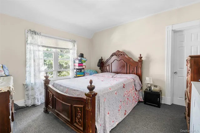 a bed sitting in a bedroom next to a window