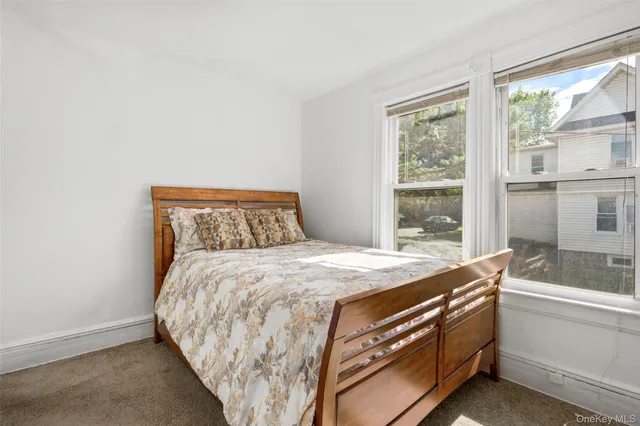 a bed sitting in a bedroom next to a window