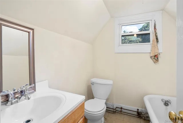 a bathroom with a toilet a sink and a window