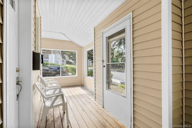 a view of balcony with wooden floor