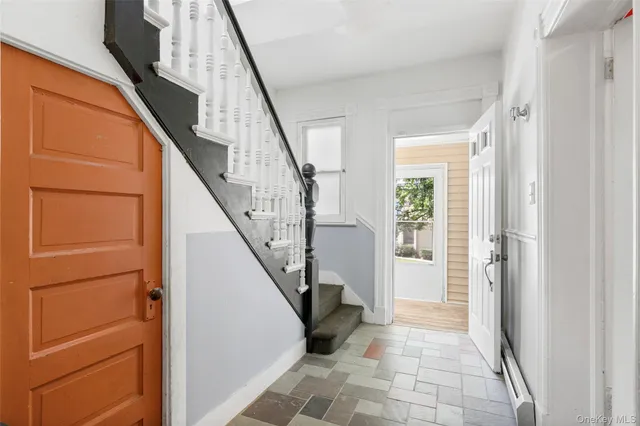 a view of entryway with wooden floor and stairs