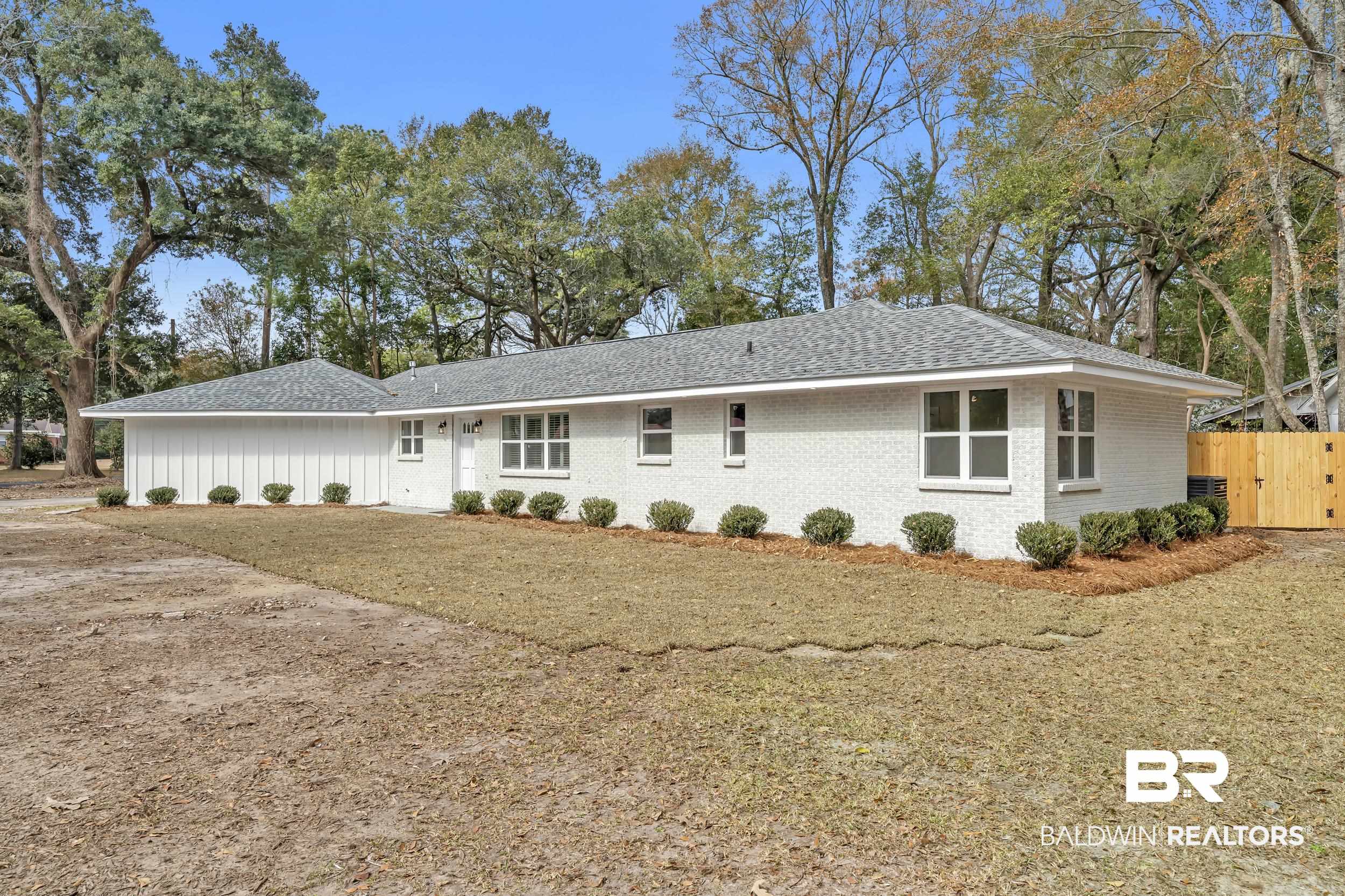 1409 Altair Lane Mobile, AL 36693 - Photo 20 of 23 Rear view of house with brick siding, a gate, and a shingled roof