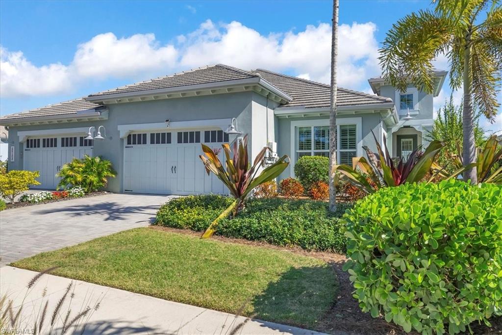 5756 Elbow Avenue Naples, FL 34113 - Photo 1 of 45 View of front facade featuring a garage, decorative driveway, stucco siding, and a tiled roof