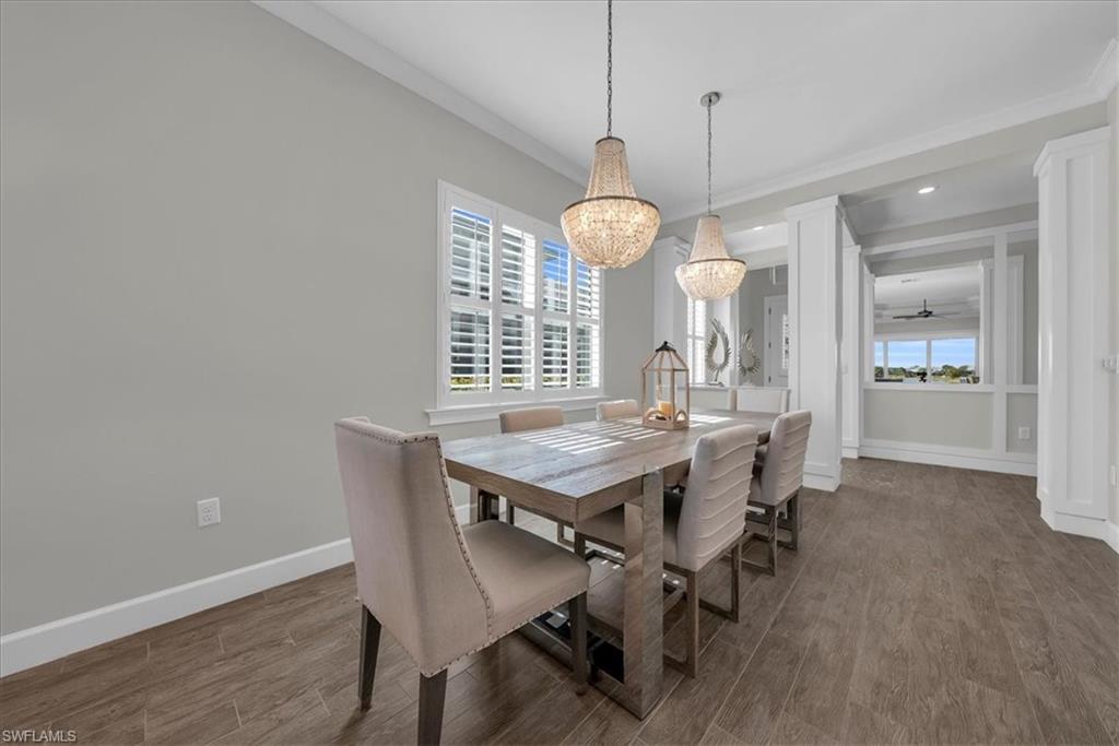 5756 Elbow Avenue Naples, FL 34113 - Photo 12 of 45 Dining area with wood finished floors, ceiling fan, crown molding, recessed lighting, and a chandelier