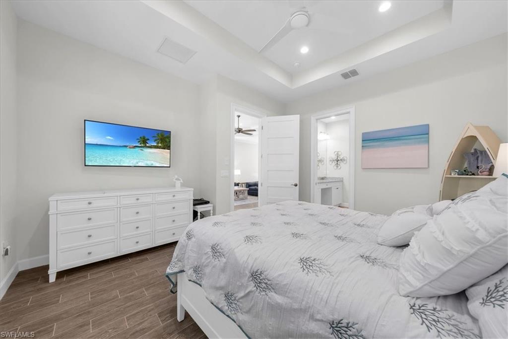 5756 Elbow Avenue Naples, FL 34113 - Photo 16 of 45 Bedroom with wood tiled floors, a closet, and ceiling fan