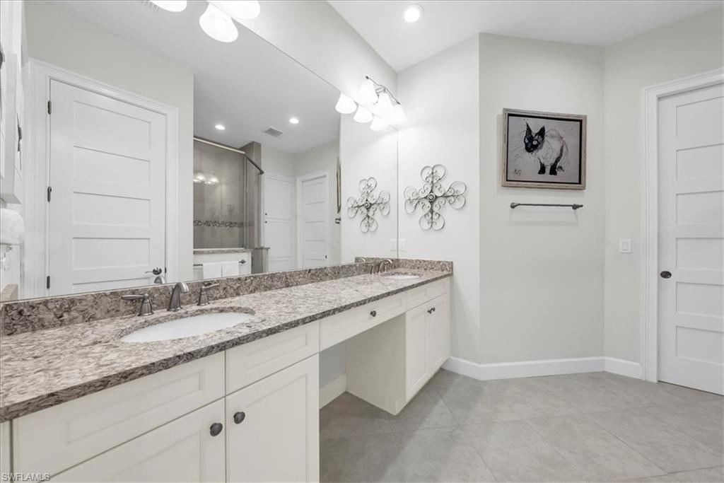 5756 Elbow Avenue Naples, FL 34113 - Photo 17 of 45 Bathroom with vanity, shower / tub combo with curtain, and dark wood-type flooring