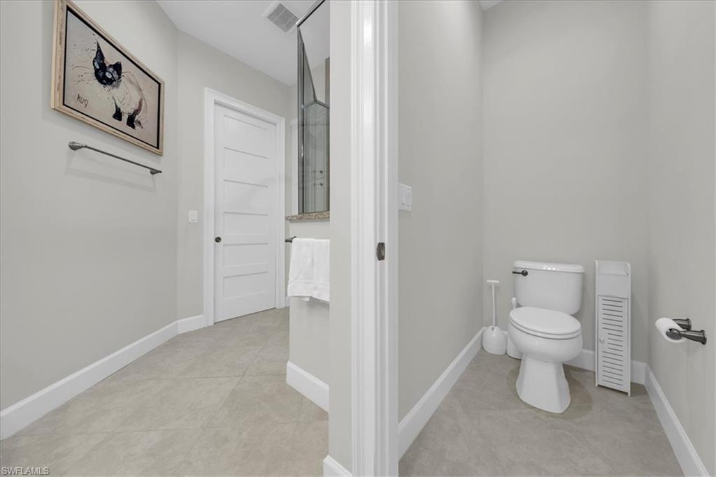 5756 Elbow Avenue Naples, FL 34113 - Photo 19 of 45 Master Bathroom featuring baseboards and toilet