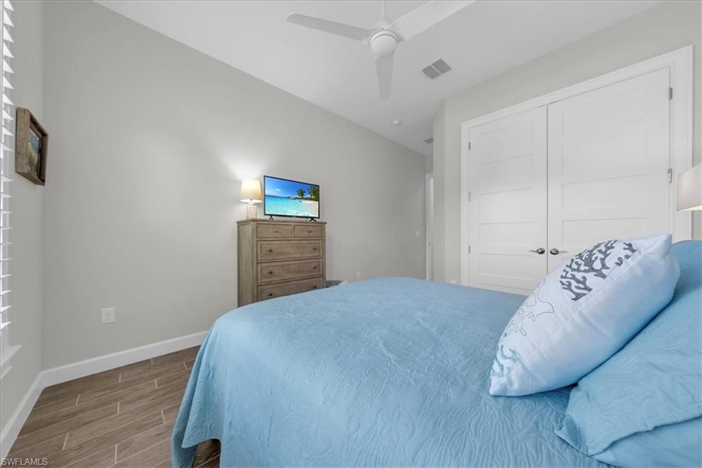 5756 Elbow Avenue Naples, FL 34113 - Photo 23 of 45 Bathroom featuring ensuite bathroom, double vanity, a stall shower, and light tile patterned floors