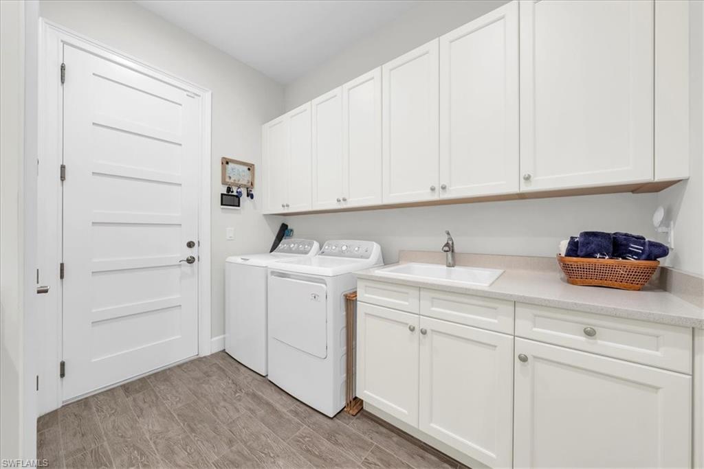 5756 Elbow Avenue Naples, FL 34113 - Photo 26 of 45 Garage featuring a garage door opener