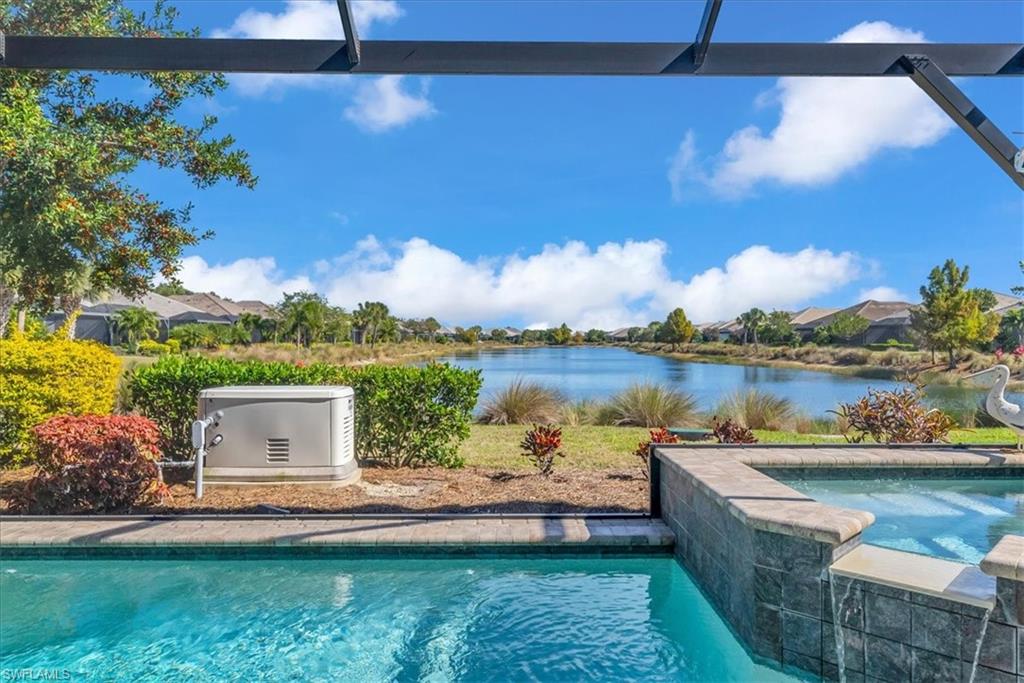 5756 Elbow Avenue Naples, FL 34113 - Photo 3 of 45 View of swimming pool with a water view, a patio, and a pool with connected hot tub