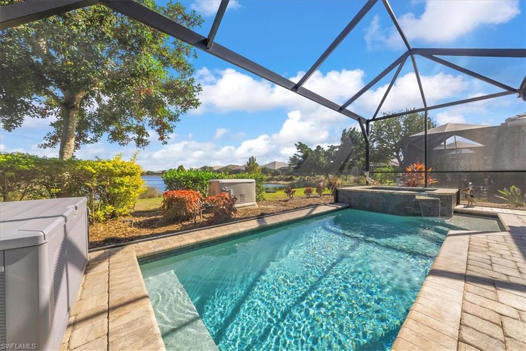 5756 Elbow Avenue Naples, FL 34113 - Photo 4 of 45 View of swimming pool featuring a lanai, a sunroom, a pool with connected hot tub, and a patio