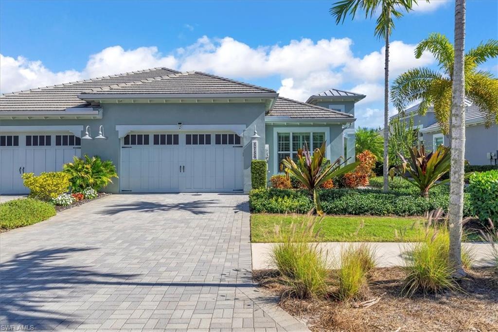 5756 Elbow Avenue Naples, FL 34113 - Photo 43 of 45 View of front of home with stucco siding, decorative driveway, and an attached garage